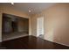 Neutral living room with hardwood flooring, carpet in the adjacent room, and a staircase at 10511 Loma Portal Ave, Las Vegas, NV 89166