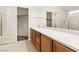 Ensuite bathroom with a double sink, vanity, large mirror, and tiled floors at 1101 Devon Downs Ave, Henderson, NV 89015