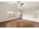 Primary bedroom featuring wood floors, ceiling fan, vaulted ceilings, and many windows at 1101 Devon Downs Ave, Henderson, NV 89015