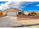 Charming single-story home with a well-manicured front yard and two-car garage at 1101 Devon Downs Ave, Henderson, NV 89015