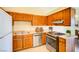 Functional kitchen with stainless steel appliances and wooden cabinets, blending style with practicality at 1306 Capri Dr # C, Boulder City, NV 89005