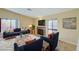 Staged living room with fireplace, balcony, and natural light, creating a cozy and inviting atmosphere at 1306 Capri Dr # C, Boulder City, NV 89005