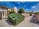 Inviting walkway leads to home with mature landscaping, enhancing its curb appeal and serene ambiance at 1306 Capri Dr # C, Boulder City, NV 89005