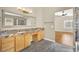 Bathroom featuring double sinks, granite counters, wood cabinets, and a large mirror at 1323 Winter Solstice Ave, Henderson, NV 89014