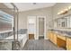 Bathroom featuring a bathtub, shower, granite counters, wood cabinets, and a large mirror at 1323 Winter Solstice Ave, Henderson, NV 89014