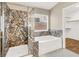 Bathroom with glass shower, bathtub, and a window providing natural light at 1323 Winter Solstice Ave, Henderson, NV 89014