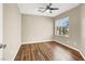Bright bedroom with a ceiling fan, wood floors, and natural light from a window at 1323 Winter Solstice Ave, Henderson, NV 89014