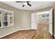 Bedroom featuring wood floors, a ceiling fan, and large windows at 1323 Winter Solstice Ave, Henderson, NV 89014
