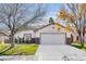 Attractive single-story home featuring a well-manicured lawn, mature trees, and a convenient two-car garage at 1323 Winter Solstice Ave, Henderson, NV 89014