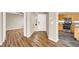 Open concept: Foyer with adjacent views into the kitchen, dining, and living areas, showcasing the hardwood floors at 1323 Winter Solstice Ave, Henderson, NV 89014