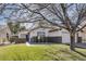 Charming single-story home featuring a well-manicured front yard with mature trees and an attached garage at 1323 Winter Solstice Ave, Henderson, NV 89014