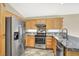 Well-lit kitchen featuring stainless steel appliances, granite countertops, and wood cabinets at 1323 Winter Solstice Ave, Henderson, NV 89014