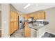 Kitchen with wood cabinets, granite countertops and stainless steel refrigerator at 1323 Winter Solstice Ave, Henderson, NV 89014