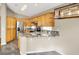 Open kitchen with wood cabinets, granite countertops and stainless appliances at 1323 Winter Solstice Ave, Henderson, NV 89014