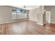 Bright, open living room featuring hardwood floors, a modern ceiling fan, and large windows for natural light at 1323 Winter Solstice Ave, Henderson, NV 89014