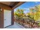 Balcony with metal guard rail, door access, and views of trees and blue skies at 1405 San Juan Hills Dr # 104, Las Vegas, NV 89134