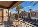 Balcony view showcasing the community, lush palm trees, well-maintained exteriors, and clear blue skies at 1405 San Juan Hills Dr # 104, Las Vegas, NV 89134