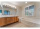 Bright bathroom with a large soaking tub, double sinks, and wooden shuttered windows at 1405 San Juan Hills Dr # 104, Las Vegas, NV 89134
