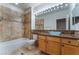 Bathroom featuring granite countertops, tiled backsplash, vessel sink, and tub with tiled surround at 1405 San Juan Hills Dr # 104, Las Vegas, NV 89134
