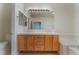 Bathroom featuring double sink vanity with wooden drawers, a large mirror, and bright lighting at 1405 San Juan Hills Dr # 104, Las Vegas, NV 89134
