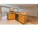 Kitchen featuring granite countertops, cabinets, and breakfast bar, leading to a living area at 1405 San Juan Hills Dr # 104, Las Vegas, NV 89134