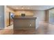 Open kitchen featuring stainless steel appliances, breakfast bar, ample cabinetry and wood laminate flooring at 1405 San Juan Hills Dr # 104, Las Vegas, NV 89134