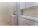 Convenient laundry room features a stacked washer/dryer and built-in cabinets for storage at 1405 San Juan Hills Dr # 104, Las Vegas, NV 89134