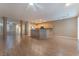 Spacious living room area with wood floors, neutral paint, and open to the kitchen with ceiling fan at 1405 San Juan Hills Dr # 104, Las Vegas, NV 89134