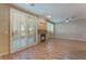 Bright living room featuring wood floors, patio access, and stone accented fireplace at 1405 San Juan Hills Dr # 104, Las Vegas, NV 89134