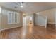 Bright living room with wood floors, staircase, and plantation shutters at 1405 San Juan Hills Dr # 104, Las Vegas, NV 89134