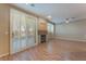 Bright living room featuring wood floors, patio access, and stone accented fireplace at 1405 San Juan Hills Dr # 104, Las Vegas, NV 89134
