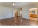 Spacious main bedroom with wood floors, a ceiling fan, and doorways to other rooms and the primary bathroom at 1405 San Juan Hills Dr # 104, Las Vegas, NV 89134