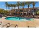 Community swimming pool with lounge chairs, a sundeck, and nearby condo residences at 1405 San Juan Hills Dr # 104, Las Vegas, NV 89134