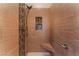 Tiled shower with a showerhead, corner seat, safety bar, and decorative tile in-lay at 1405 San Juan Hills Dr # 104, Las Vegas, NV 89134
