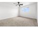 Clean, empty bedroom features neutral carpet, ceiling fan, and a window at 1612 Justin Pl # 0, Henderson, NV 89011