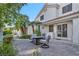 Relaxing backyard patio with palm trees, attractive patio furniture, and lush landscaping at 174 Buena Ct, Henderson, NV 89074