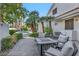 Cozy backyard patio with inviting seating area, lush landscaping, and access to the pool for ultimate relaxation at 174 Buena Ct, Henderson, NV 89074