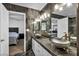 Modern bathroom with dual vessel sinks, marble wall detail, and stylish fixtures at 174 Buena Ct, Henderson, NV 89074