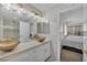 Bright bathroom featuring dual vessel sinks, marble countertops and stylish gold fixtures at 174 Buena Ct, Henderson, NV 89074