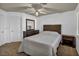 Well-lit bedroom with neutral carpet, a window, and wood furnishings at 174 Buena Ct, Henderson, NV 89074