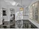 Dining area featuring shuttered windows, elegant lighting, and black marble flooring at 174 Buena Ct, Henderson, NV 89074
