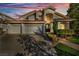 Stunning two-story home with mature landscaping, a three-car garage and a beautiful tile roof at 174 Buena Ct, Henderson, NV 89074