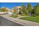 Two-story home with a three-car garage, beautifully landscaped front yard, and a brick pathway at 174 Buena Ct, Henderson, NV 89074