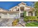 Beautiful two-story home with a three-car garage, tile roof, and manicured front yard at 174 Buena Ct, Henderson, NV 89074