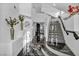 Bright foyer with a modern staircase, stylish decor, and sleek black marble flooring at 174 Buena Ct, Henderson, NV 89074