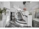 Grand foyer showcasing a modern staircase, elegant black marble floors, and bright, open space at 174 Buena Ct, Henderson, NV 89074