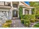 Charming front entrance with a dark door, sidelights, and manicured landscaping at 174 Buena Ct, Henderson, NV 89074