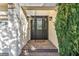 Elegant front door with sidelights, brick steps, and lush greenery at 174 Buena Ct, Henderson, NV 89074