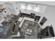 Aerial view of a modern kitchen with black marble floors, white cabinets, and stainless steel appliances at 174 Buena Ct, Henderson, NV 89074