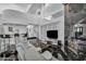 Living room boasts vaulted ceiling, fireplace, shelving and marble floors at 174 Buena Ct, Henderson, NV 89074